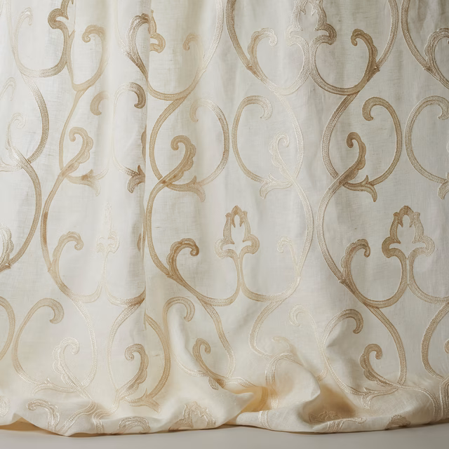 Ivory sheer fabric with large scrolling damask in warm beige tones