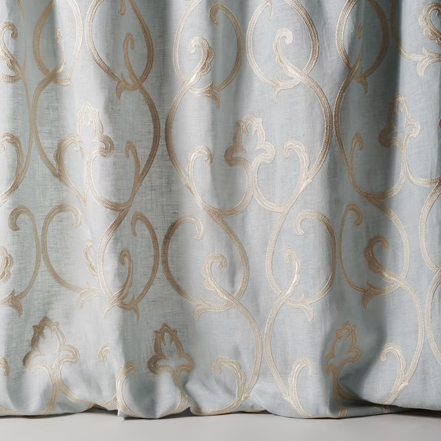 Pale dusty blue sheer fabric with large scrolling damask in ivory-beige