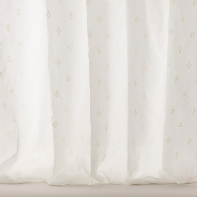 Sheer white cotton fabric with tiny pale gold scattered motifs