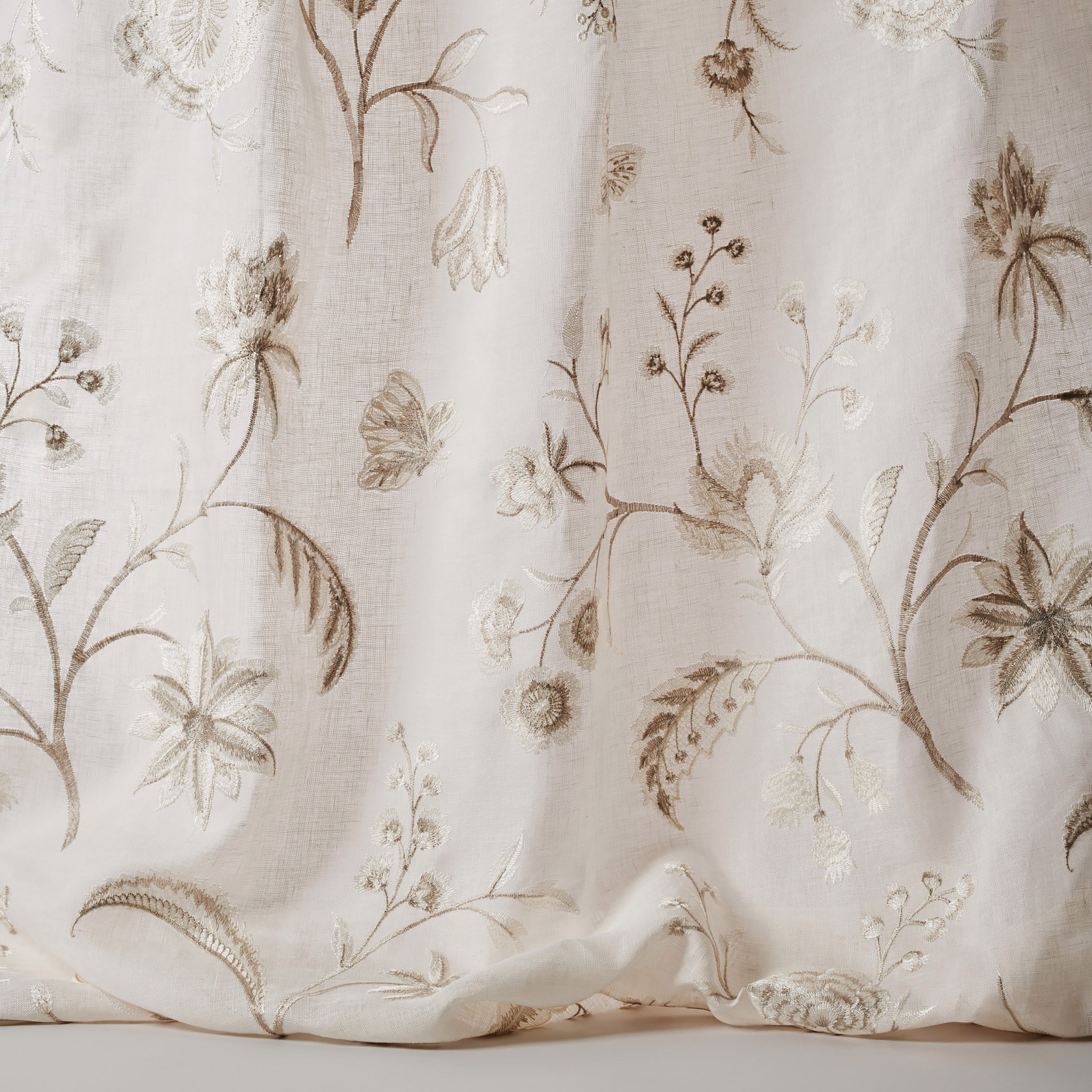 Ivory sheer fabric with large embroidered floral stems and taupe-brown detail