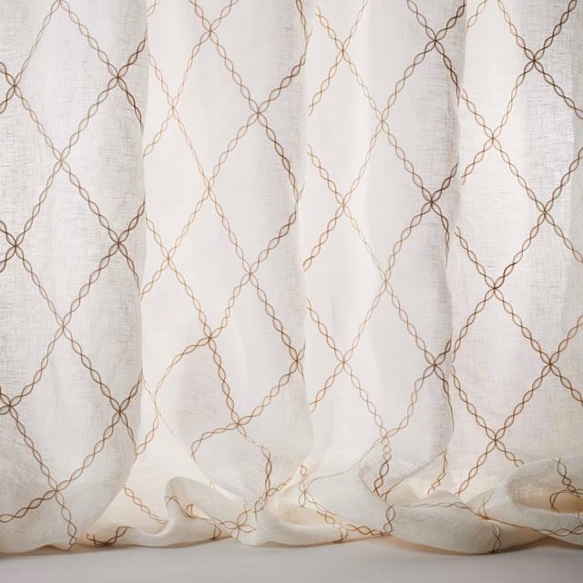 Sheer ivory linen fabric with warm beige looping lattice pattern