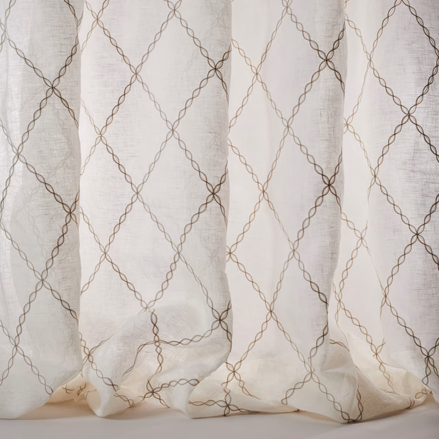Sheer ivory fabric with silver looping diamond lattice and soft linen texture