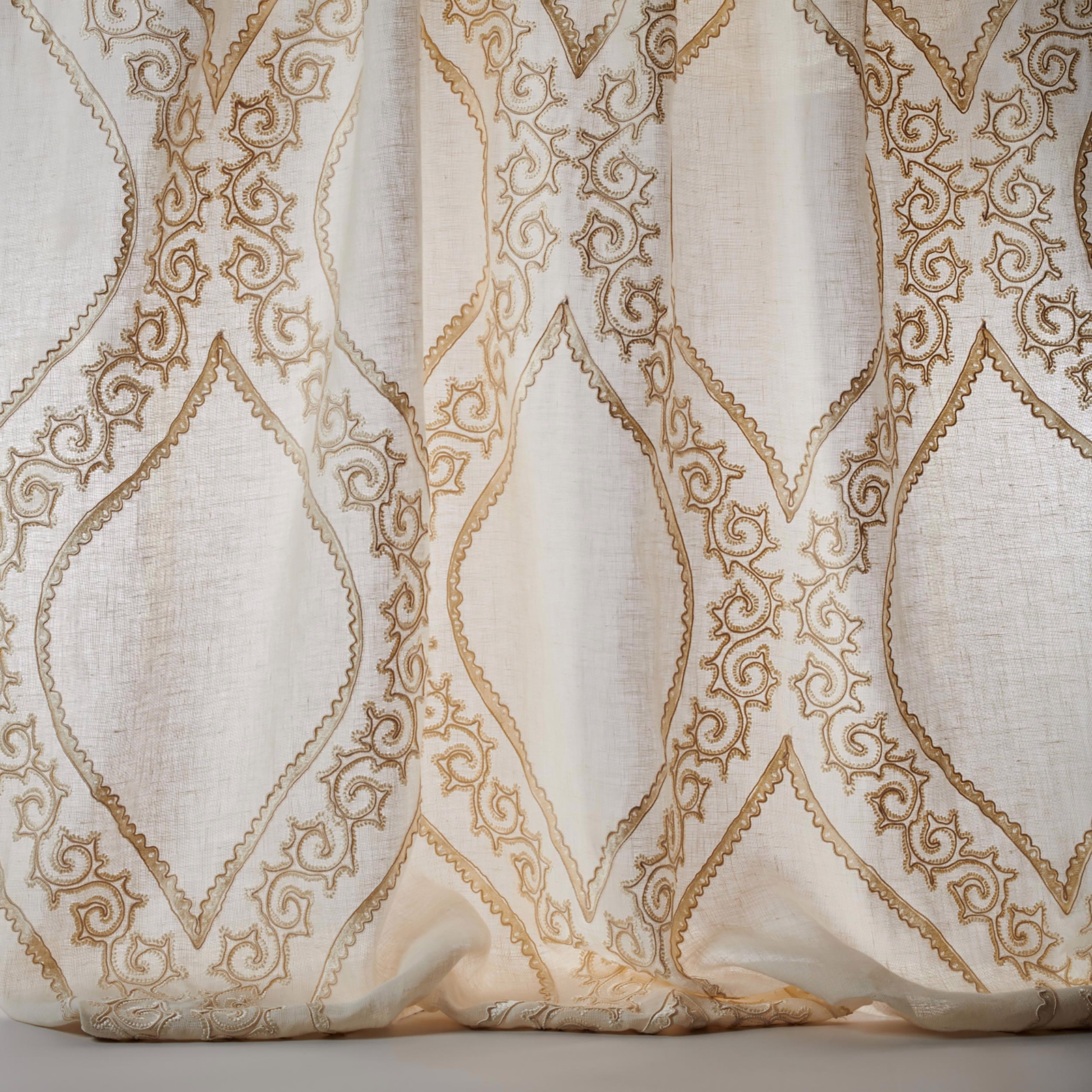 Ivory sheer fabric with gold embroidered lattice and scrolling motif