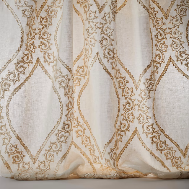 Ivory sheer fabric with gold embroidered lattice and scrolling motif