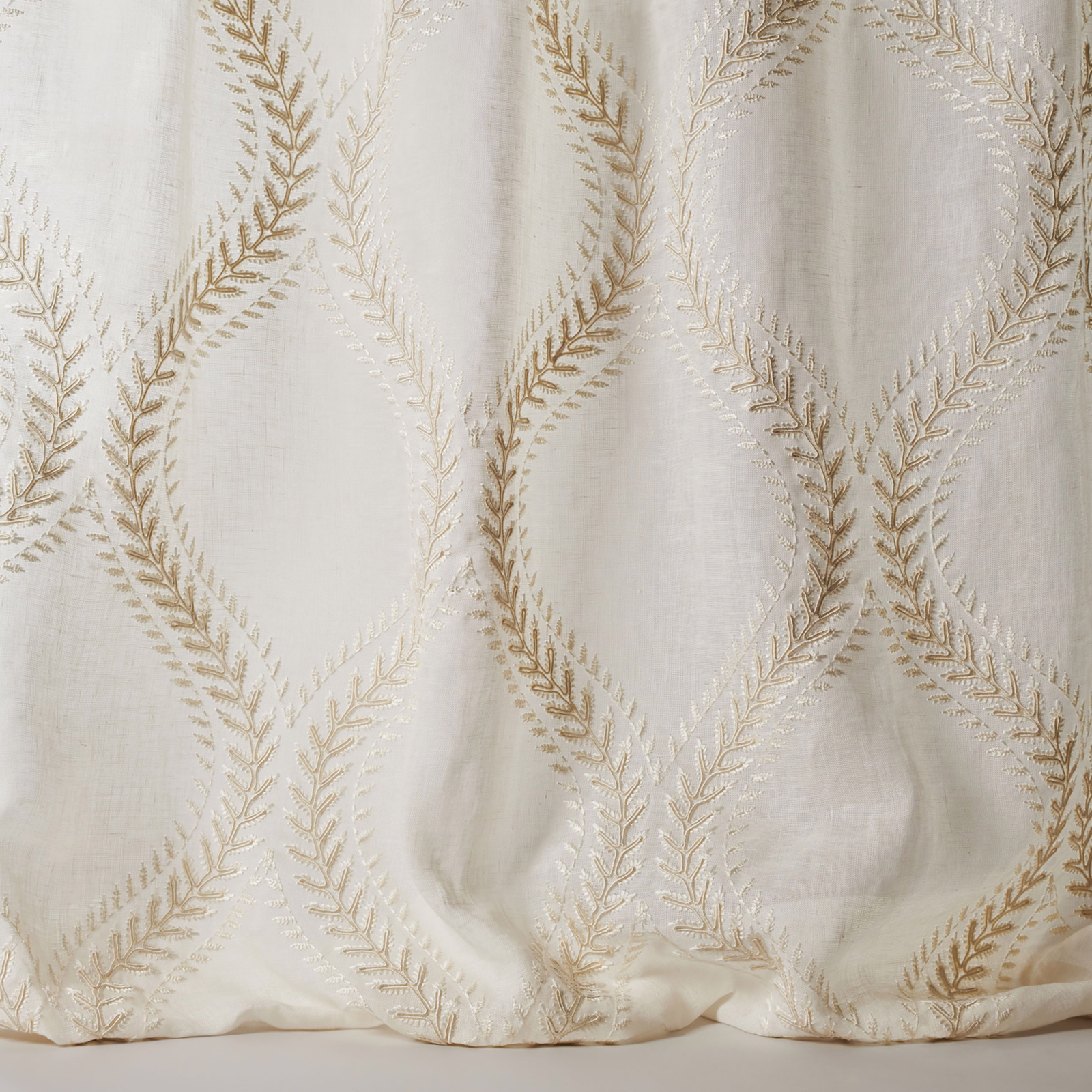 Ivory sheer fabric with large gold leaf-lattice embroidery and soft linen texture