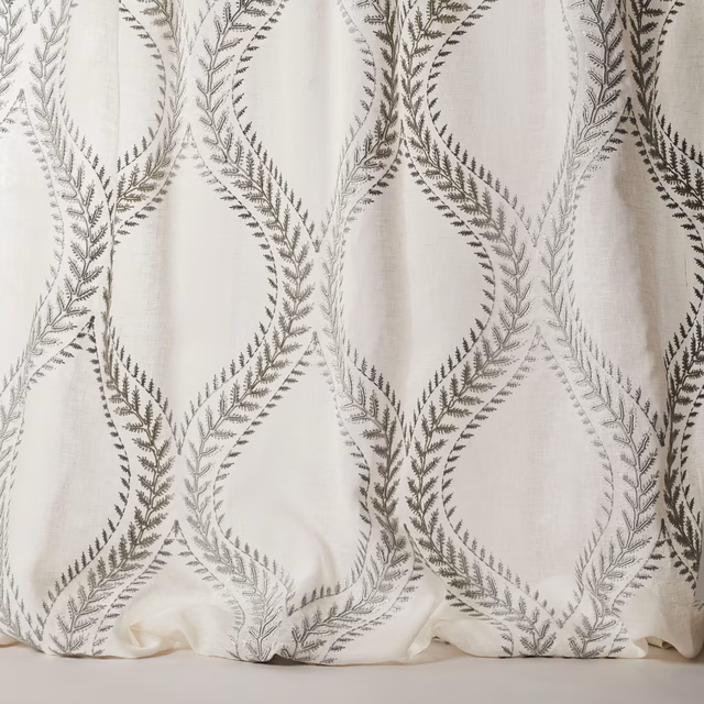 Ivory sheer fabric with large embroidered leaf loops in muted blue-grey
