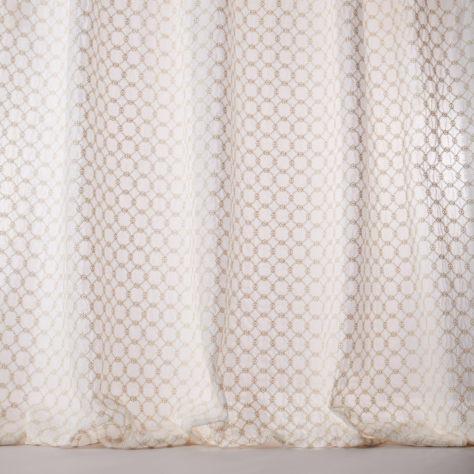 Sheer ivory cotton fabric with tiny gold geometric lattice pattern