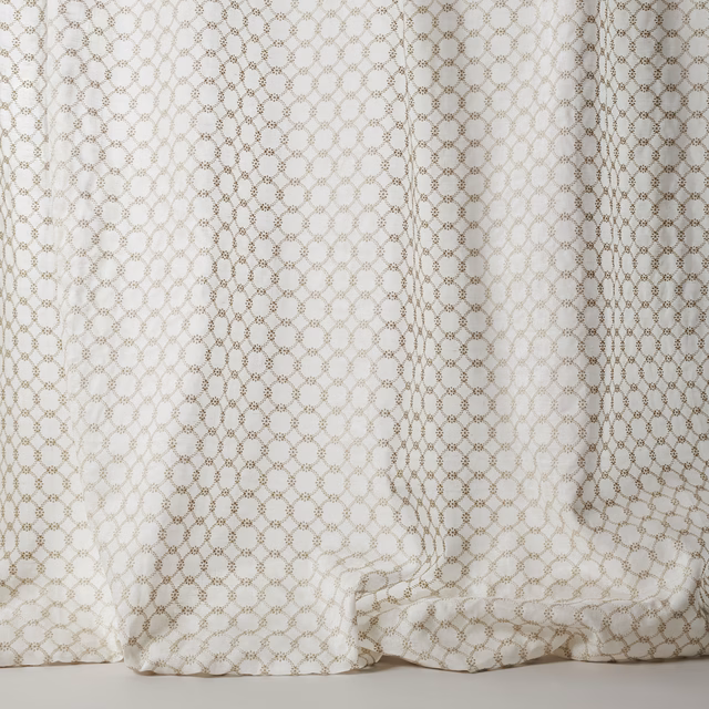 Cream sheer fabric with small taupe geometric lattice and soft drape