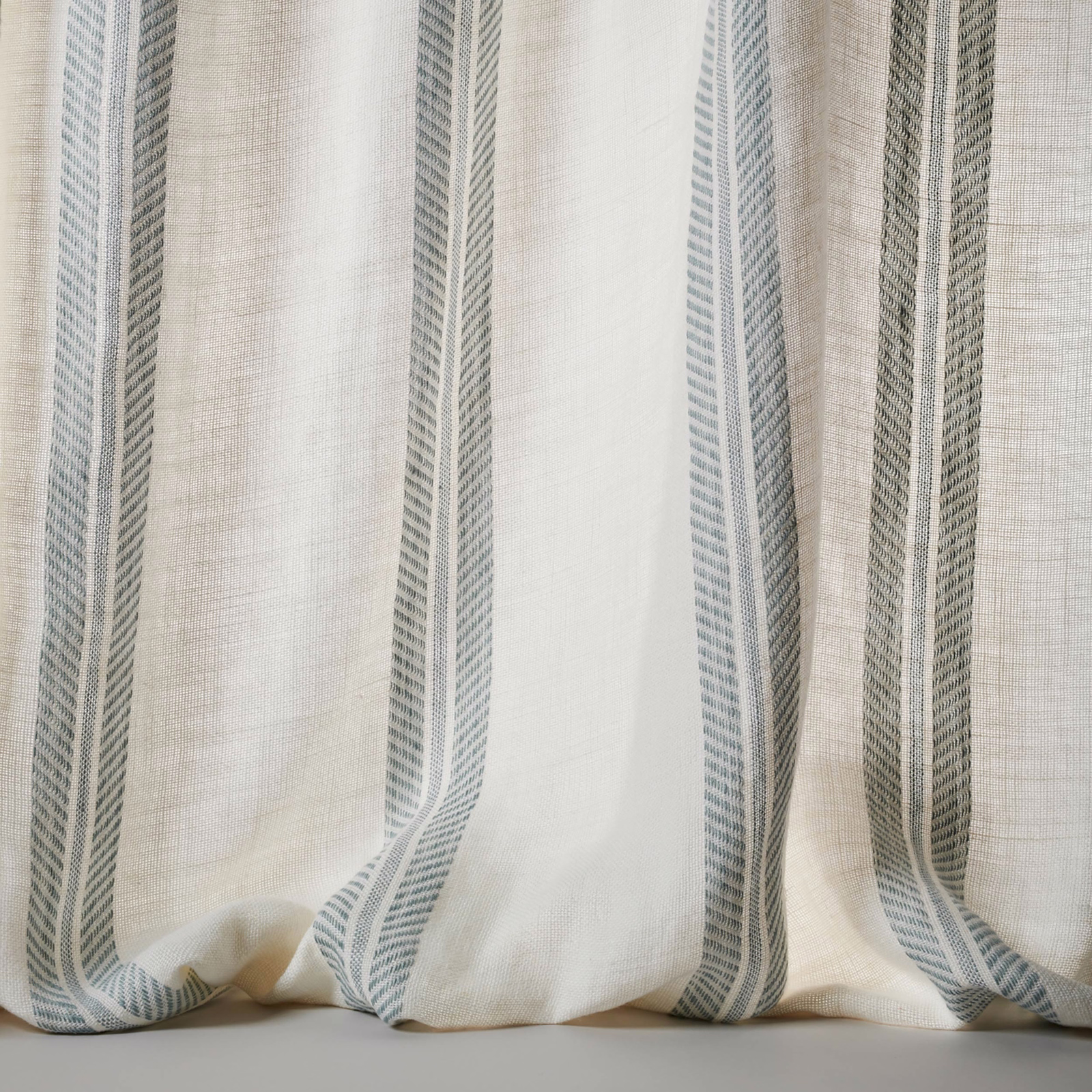 Sheer linen fabric with wide muted blue-grey vertical stripes and soft natural texture