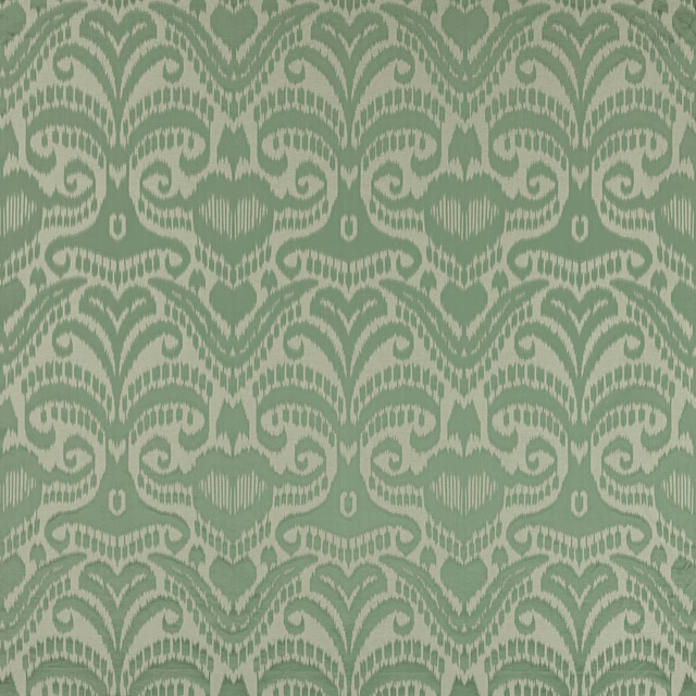 Celadon green damask fabric with scrolling motifs and a soft woven sheen