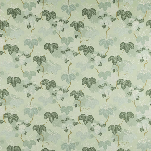 Soft opaline green botanical fabric with layered leaf motifs and ochre stems
