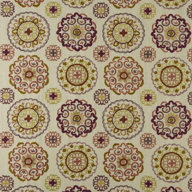 Ivory fabric swatch with circular pink, mustard and plum medallion motifs