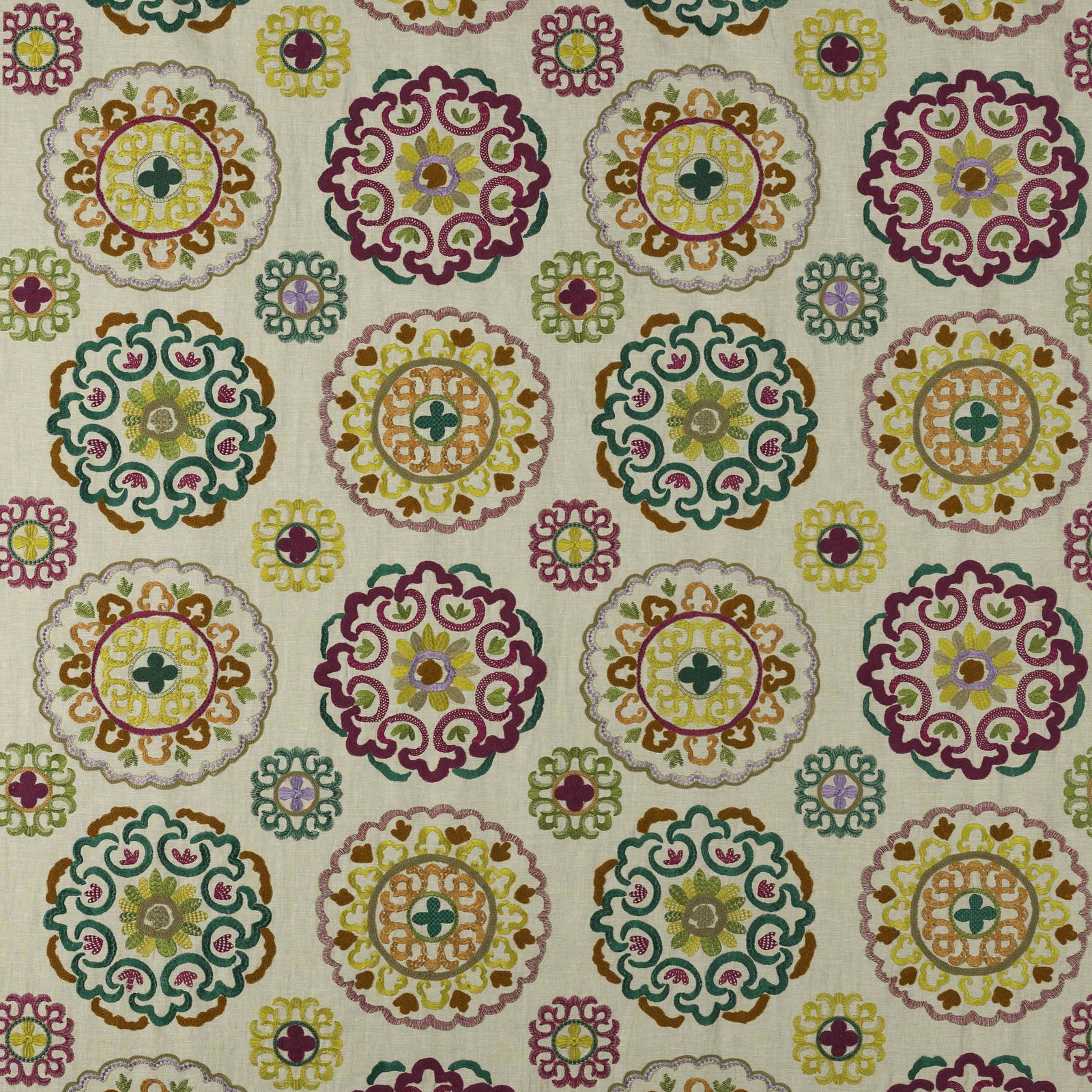 Cream fabric swatch with large fuchsia scalloped medallions and multicolour embroidered-look motifs