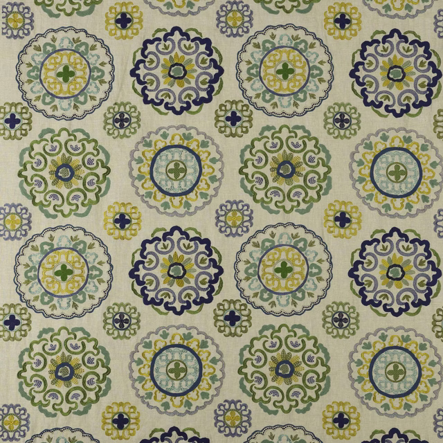 Ivory fabric swatch with repeating blue, green and yellow circular medallions