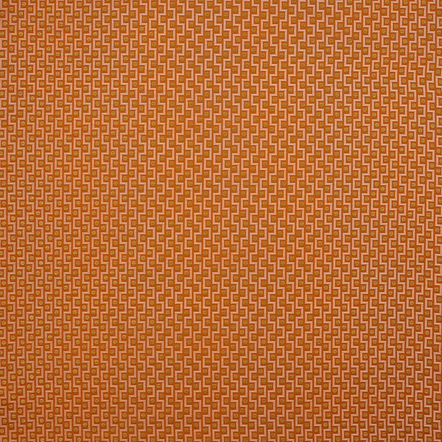 Coral orange geometric woven fabric with small repeating motif