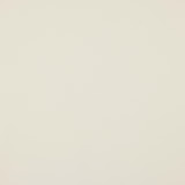 Pale ivory plain cotton fabric swatch with a smooth matte finish