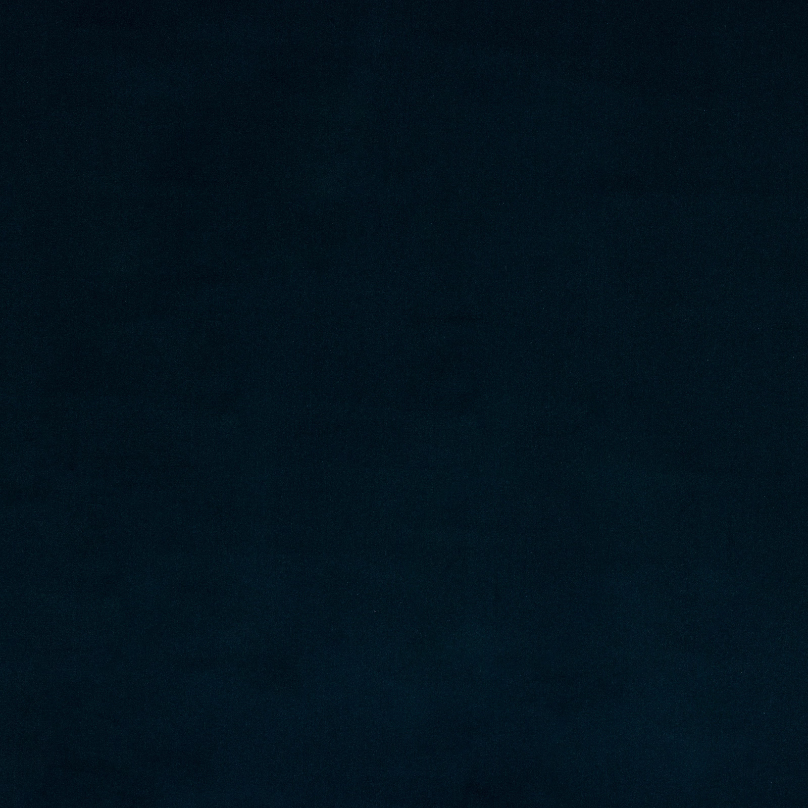 Close-up of a deep ink-blue plain cotton fabric swatch with a matte finish.