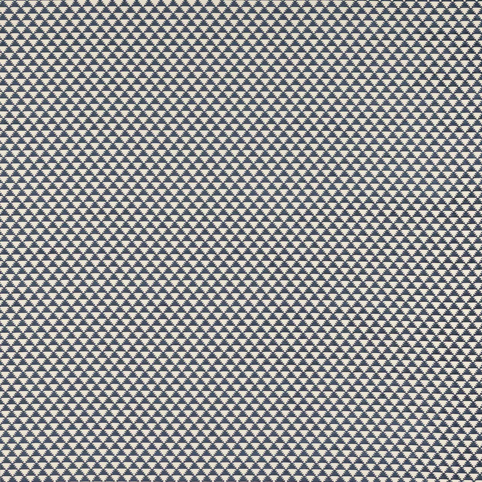 Close-up of indigo blue geometric woven fabric on a pale ground