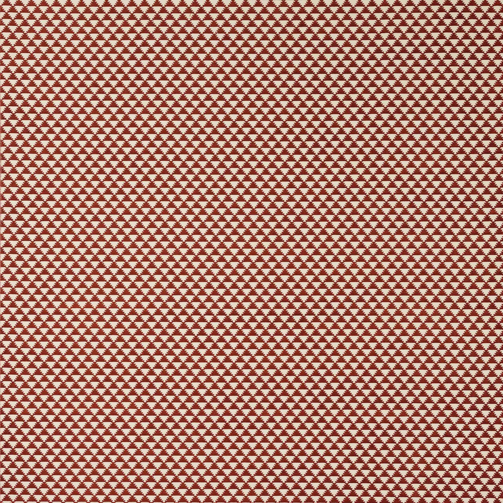 Terracotta red fabric with a small repeating ivory geometric motif