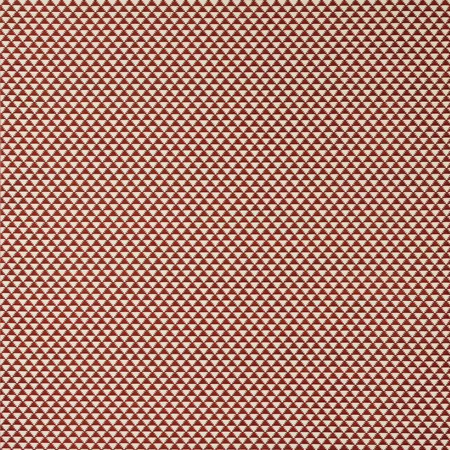 Terracotta red fabric with a small repeating ivory geometric motif