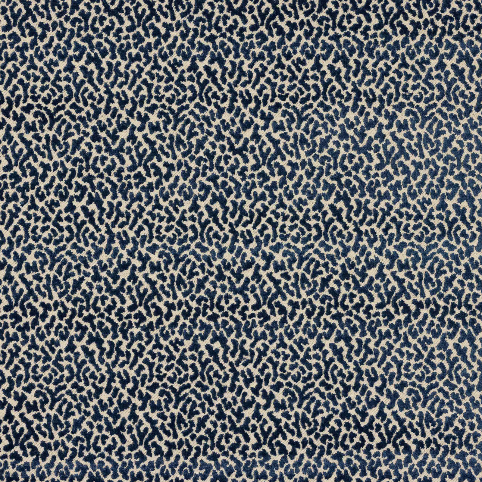 Close-up of small blue and ivory abstract woven pattern on fabric swatch