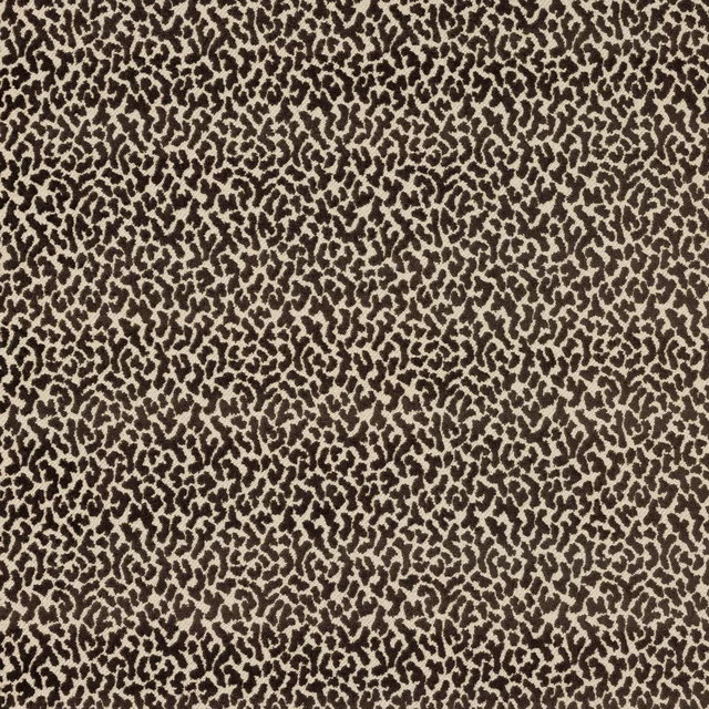 Close-up of a small brown animal spot pattern on an oatmeal woven fabric