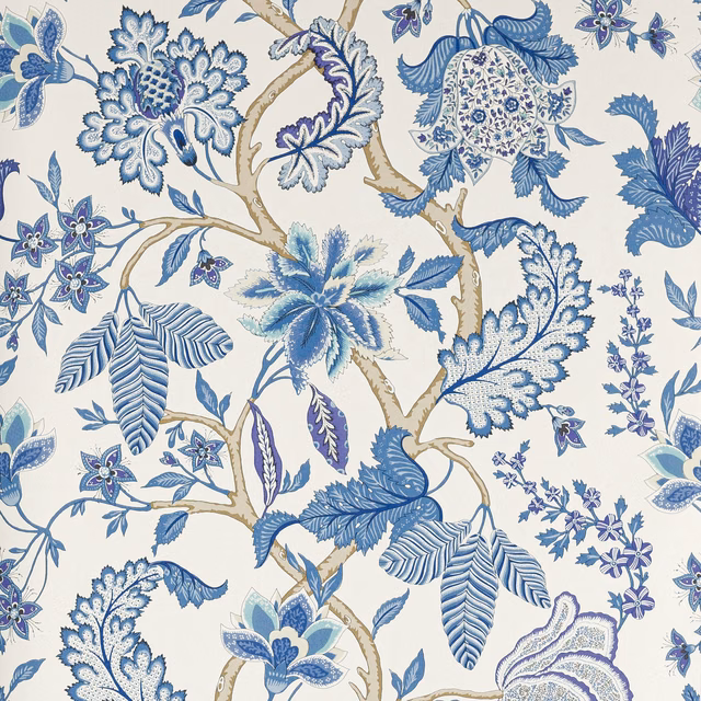 Cream wallpaper with large blue botanical flowers, leaves and beige winding branches