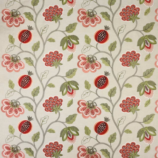 Red and green floral vine fabric on a linen ground with repeating round motifs