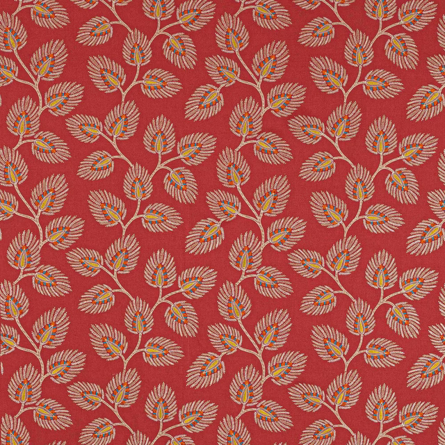 Red botanical fabric with repeating leaf sprigs in cream, orange and teal accents