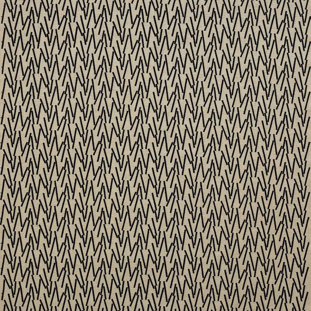 Black zigzag geometric fabric on a warm ivory ground, tightly repeated pattern