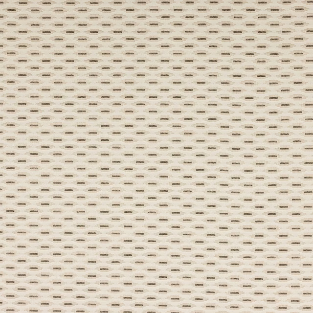 Ivory woven fabric with tiny black dash motifs scattered across the surface