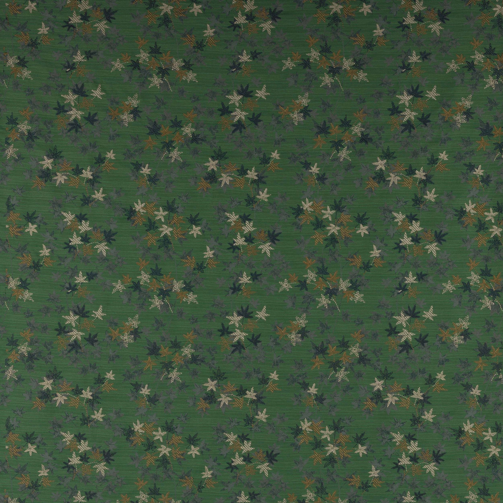 Emerald green patterned fabric with small scattered leaf flowers and muted cream accents
