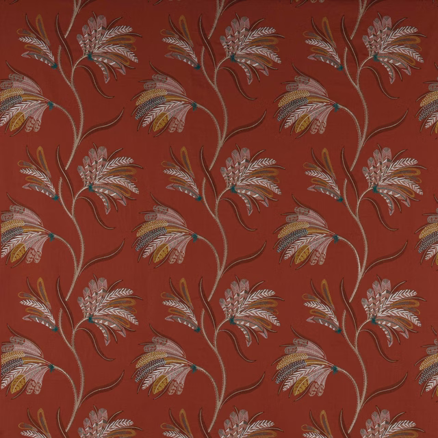Terracotta-red botanical fabric swatch with scrolling leaf motifs in ivory, taupe and mustard