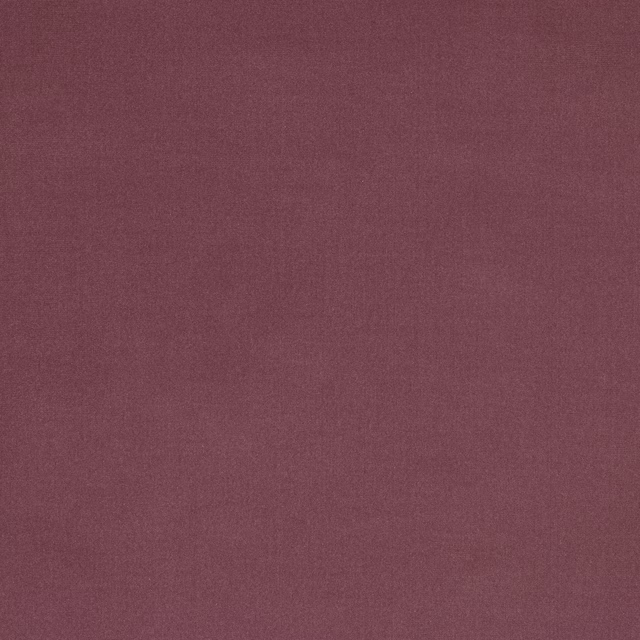 Close-up of a muted plum-mauve plain weave fabric with a smooth finish