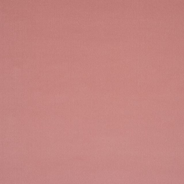 Soft dusty rose plain fabric with a smooth matte surface