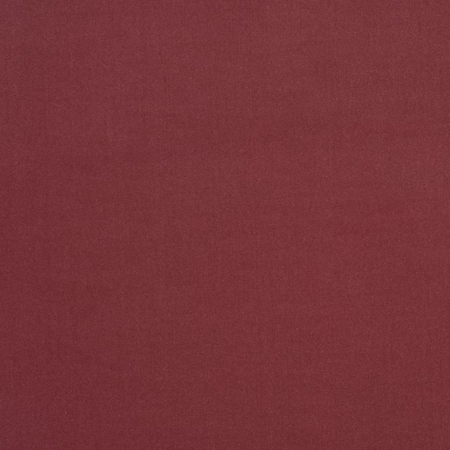 Close-up of muted dusty rose plain-woven fabric with fine texture