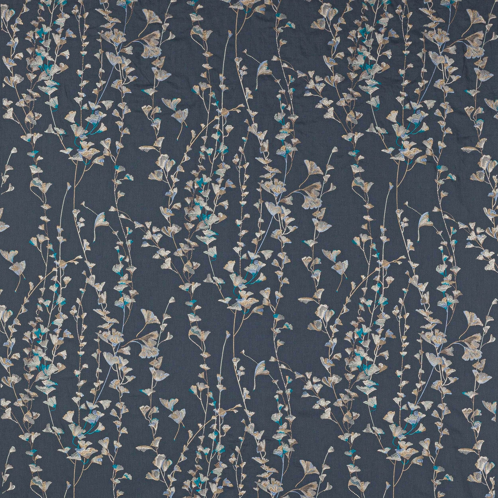 Trailing botanical floral fabric on a deep slate-blue ground with pale leaves and turquoise highlights