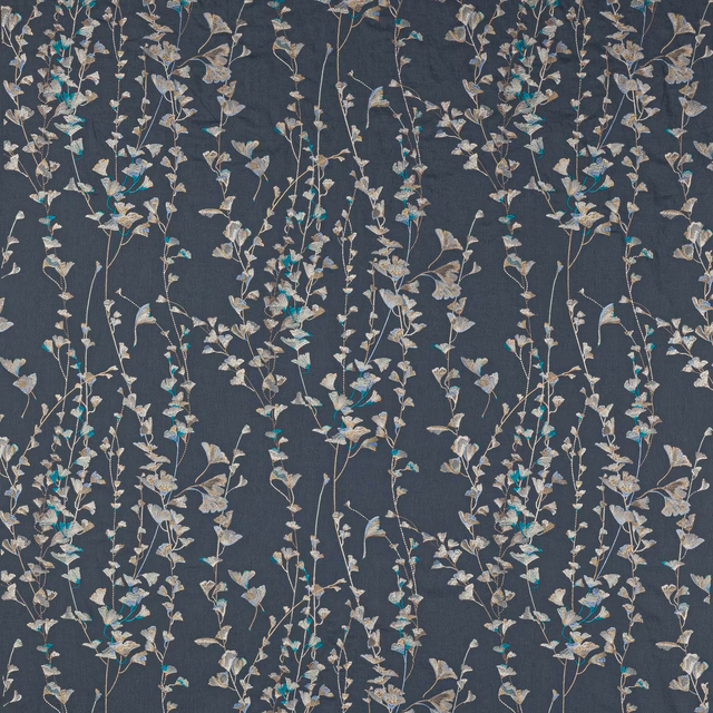 Trailing botanical floral fabric on a deep slate-blue ground with pale leaves and turquoise highlights