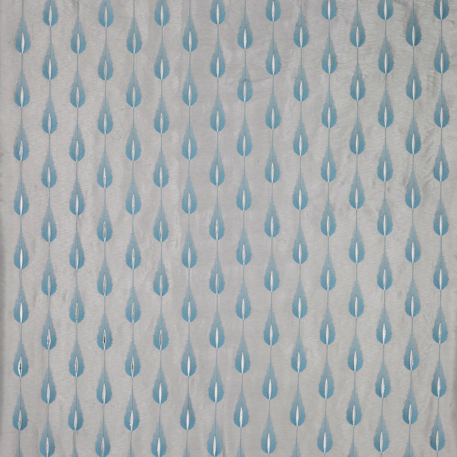 Small aqua teardrop motif on a pale textured fabric ground