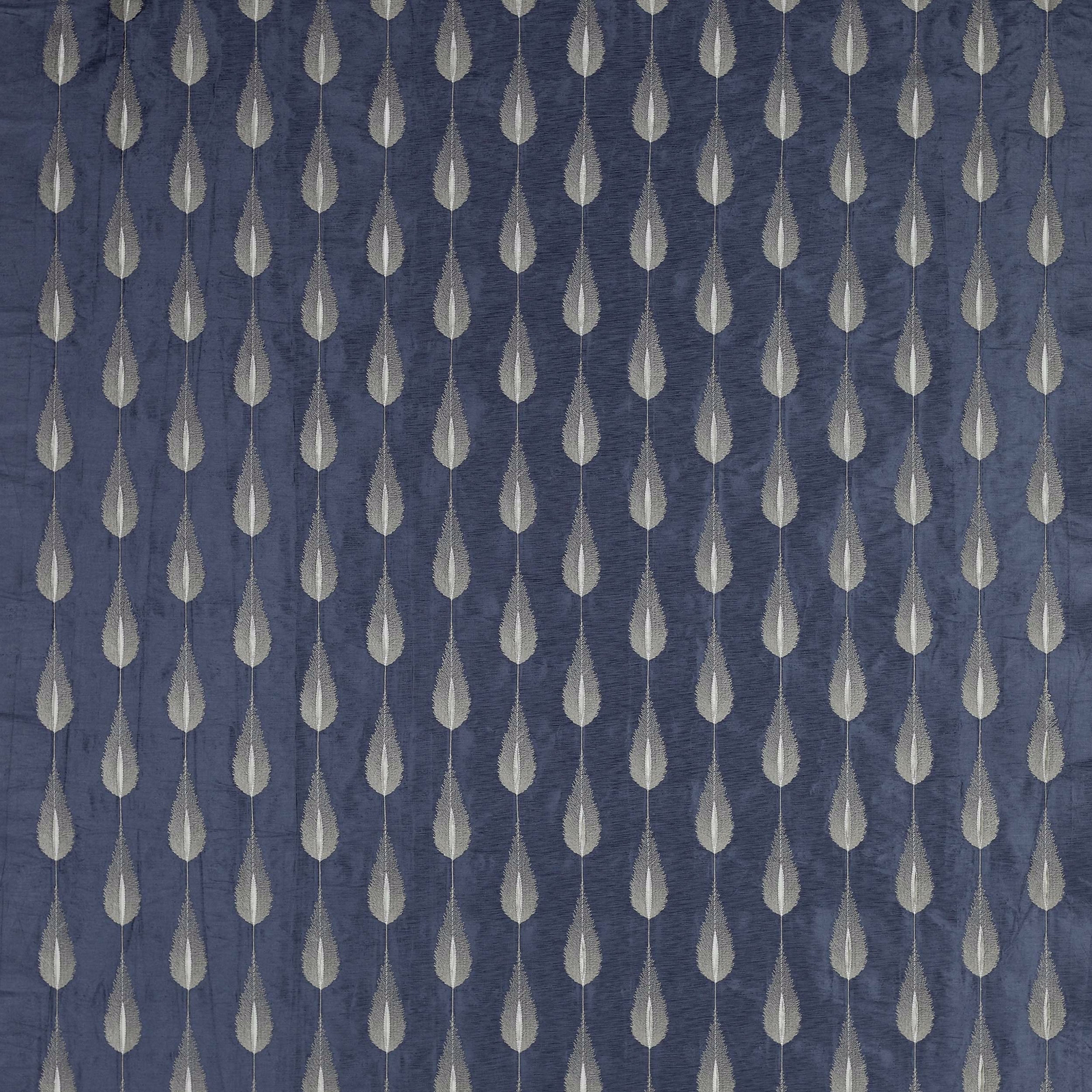 Blue patterned fabric with pale teardrop motifs on a textured ground