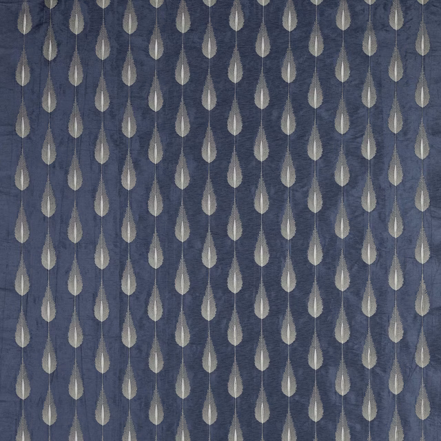 Blue patterned fabric with pale teardrop motifs on a textured ground