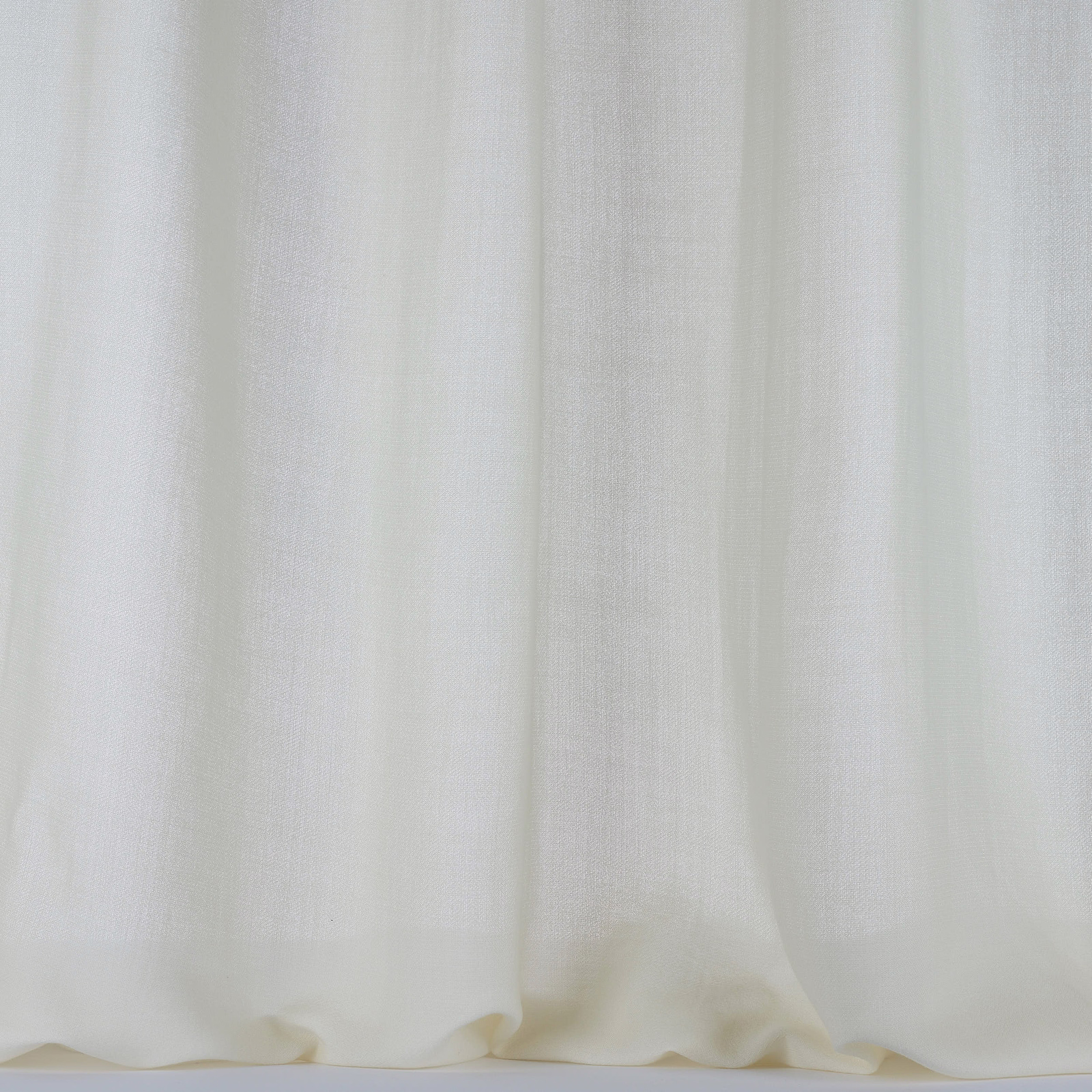 Pale bone cream wool fabric with a soft plain weave and gentle curtain folds