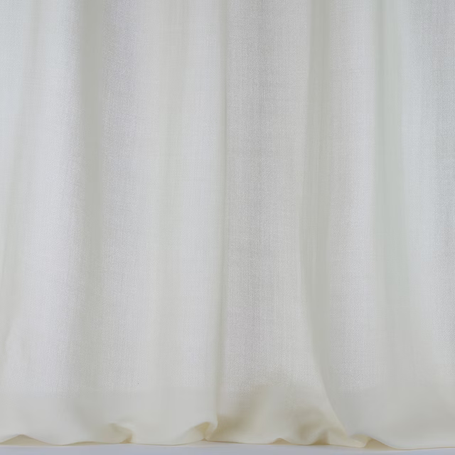 Pale bone cream wool fabric with a soft plain weave and gentle curtain folds