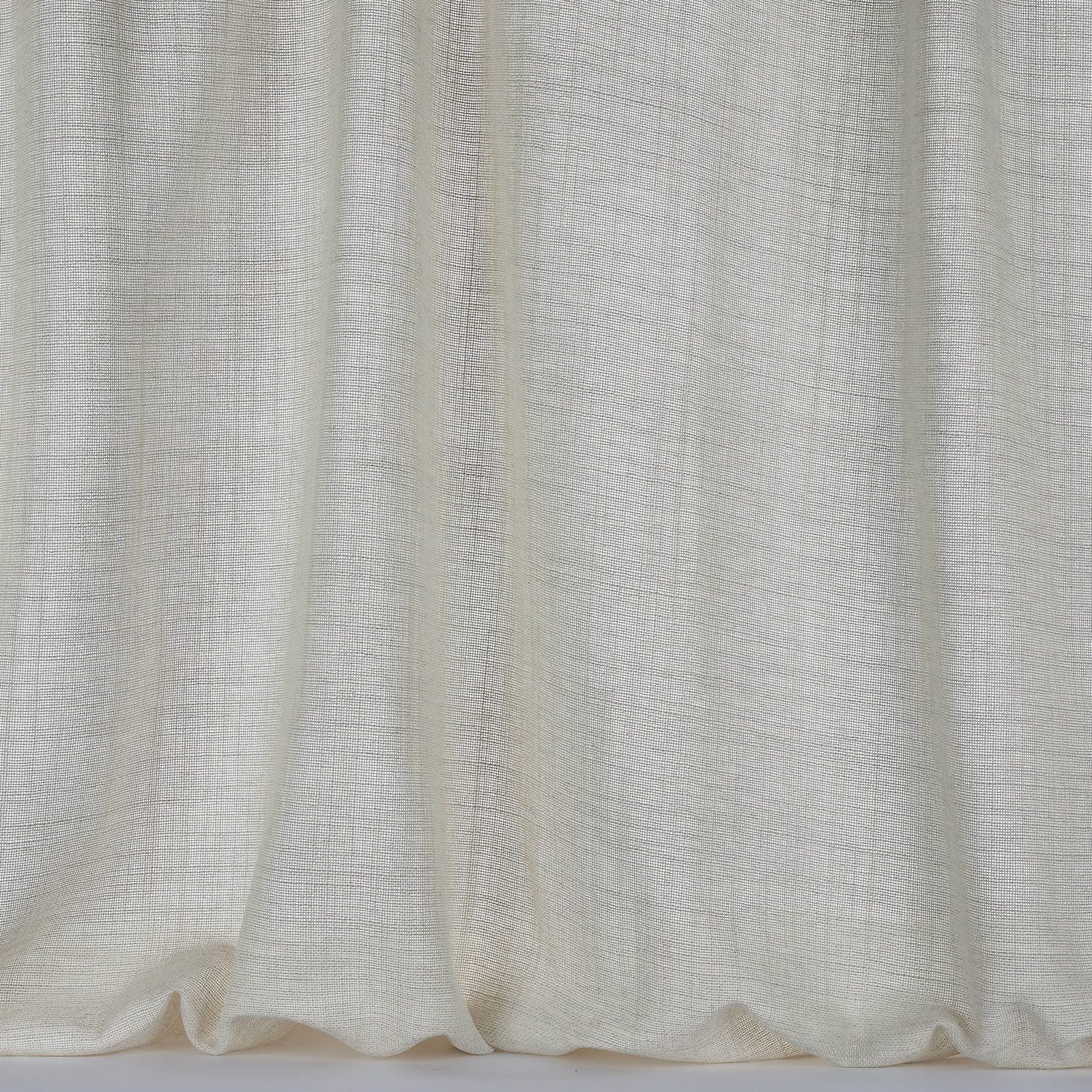 Warm cream woven curtain fabric with a fine crosshatch texture and soft folds