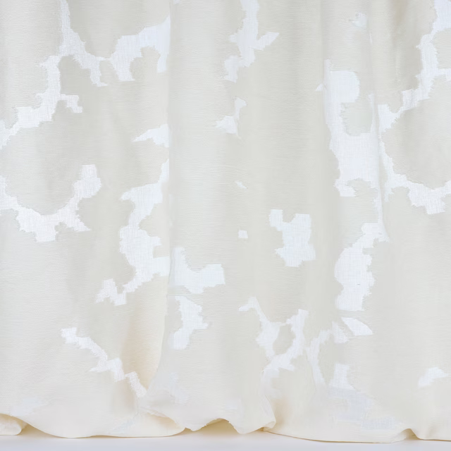 Cream fabric swatch with large abstract pale ivory pattern and subtle woven texture