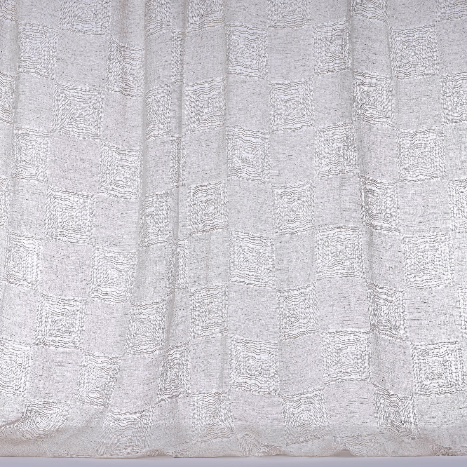 Soft white linen curtain fabric with a subtle woven grid texture