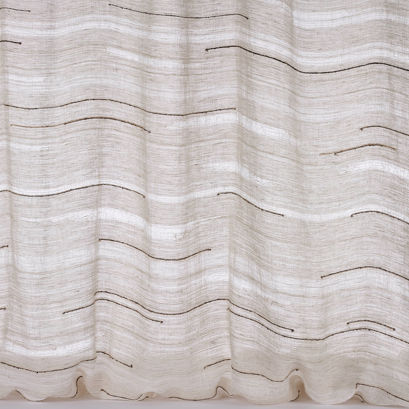 Ivory sheer fabric with fine horizontal striations and thin dark wavy lines