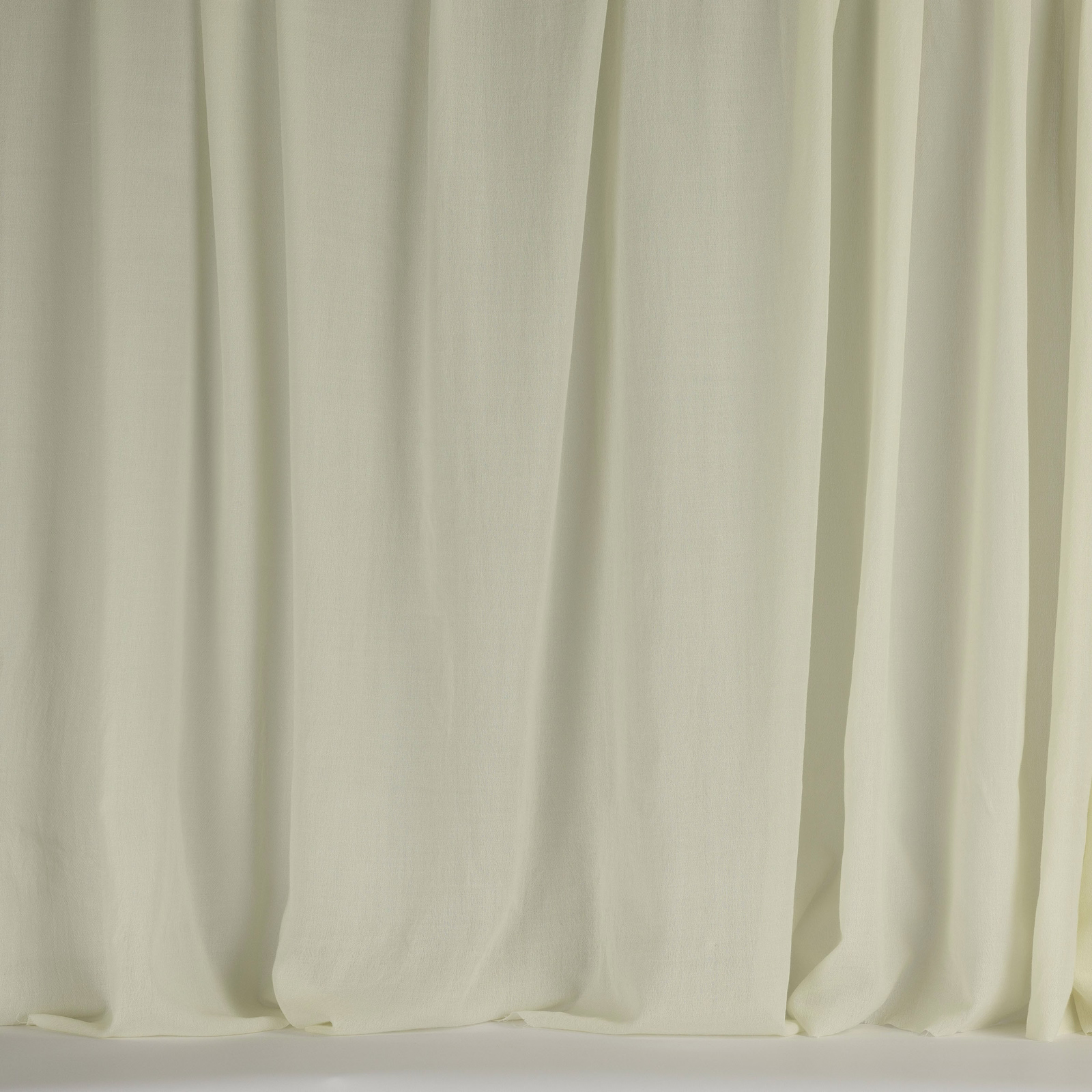 Pale ivory wool fabric with soft vertical folds and a smooth matte finish
