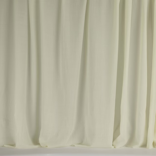 Pale ivory wool fabric with soft vertical folds and a smooth matte finish