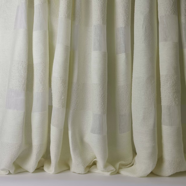 Cream woven curtain fabric with broad tonal stripes and soft textured folds